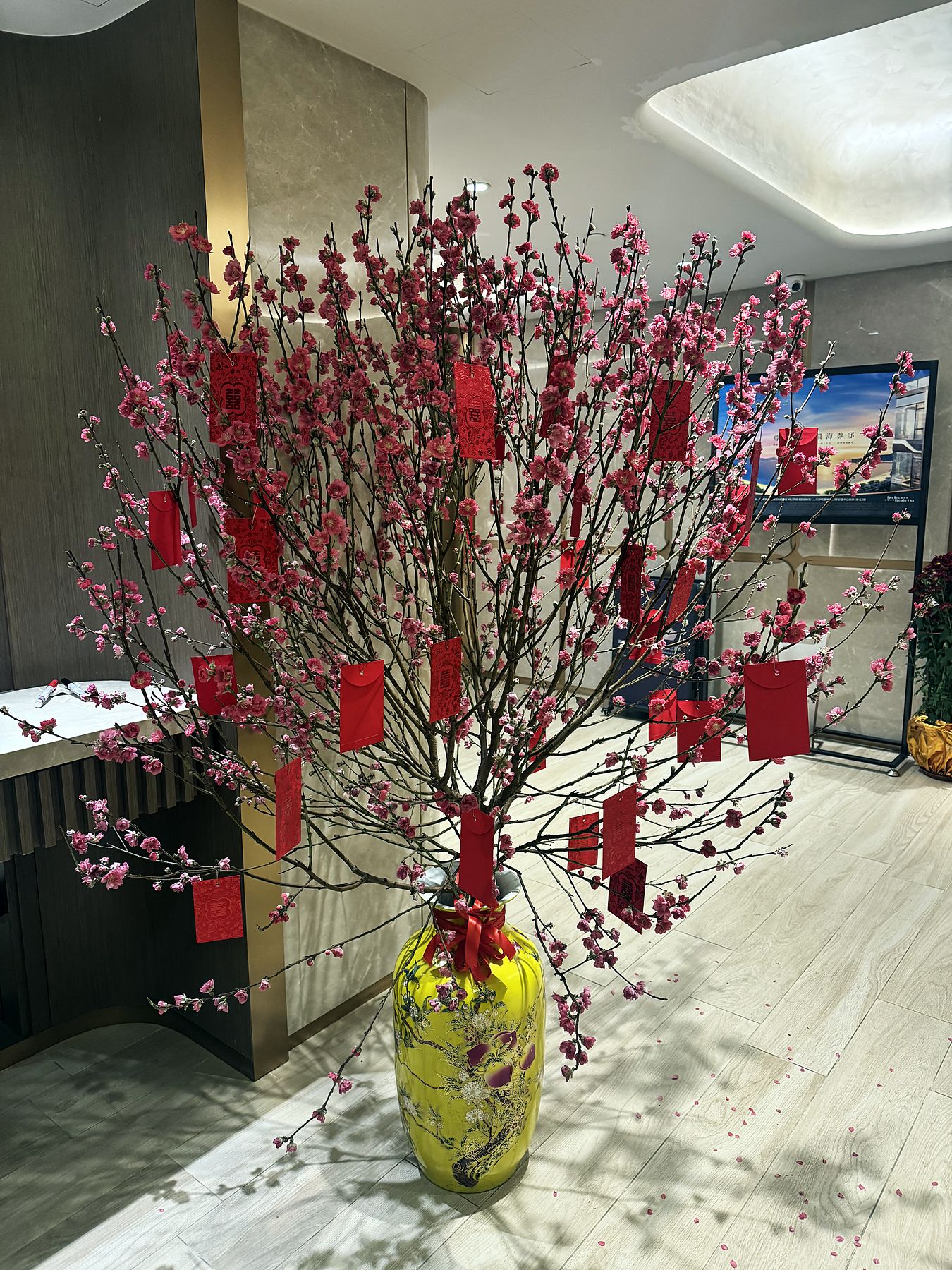 A red Lunar New Year blossom arrangement in a hotel lobby