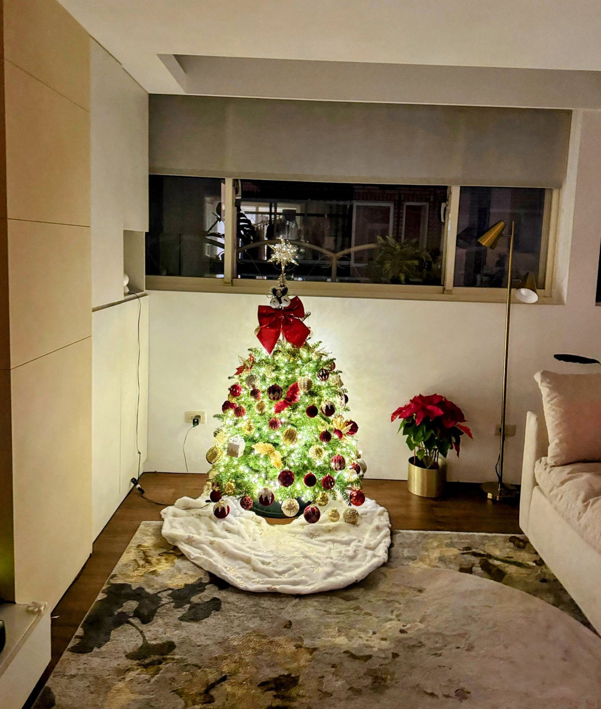 Small Christmas tree decorated in red and gold with warm lights
